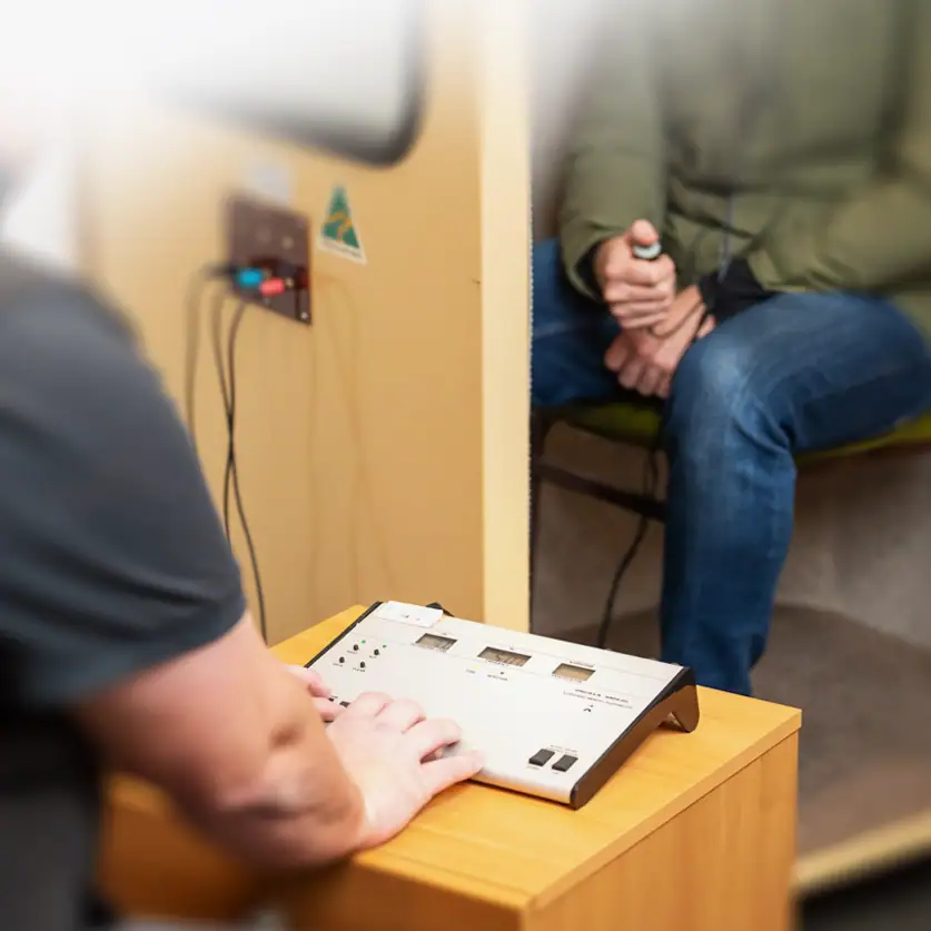 Therapist conducting a therapy session with a patient using specialized equipment.